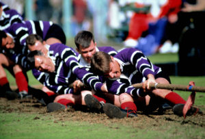 Team in purple/white in tug of war at Braemar Highland Games